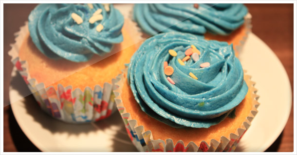 Vanilla cupcakes with baby blue buttercream frosting